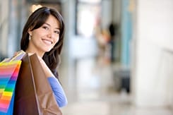 Beautiful woman holding bags in a shopping mall